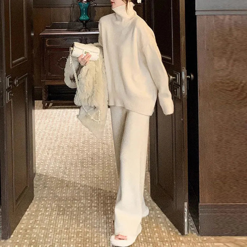 Women's beige acrylic sweater and wide-leg trousers two-piece set on a hanger
