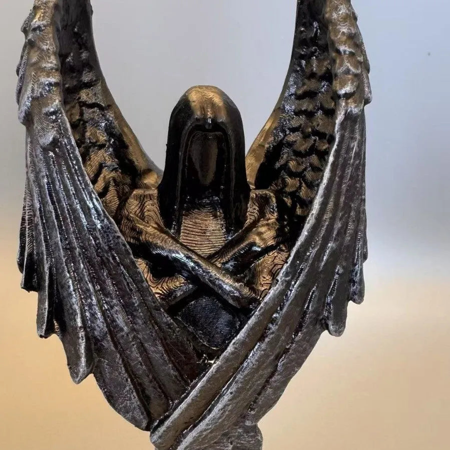 Dark coloured resin angel statue ornament with dimensions 6.5 cm by 5 cm by 17 cm.