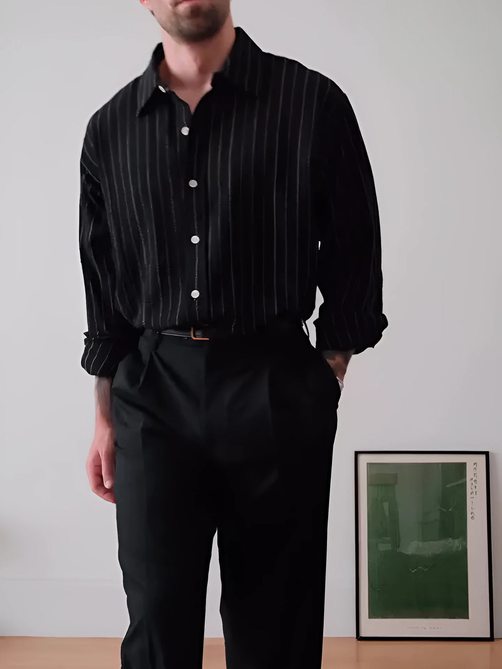 Black pinstriped polyester button-down shirt on a hanger showing regular fit