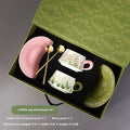 Ceramic coffee cup set with two matching cups, saucers, and stirring spoons featuring hand-painted couple designs