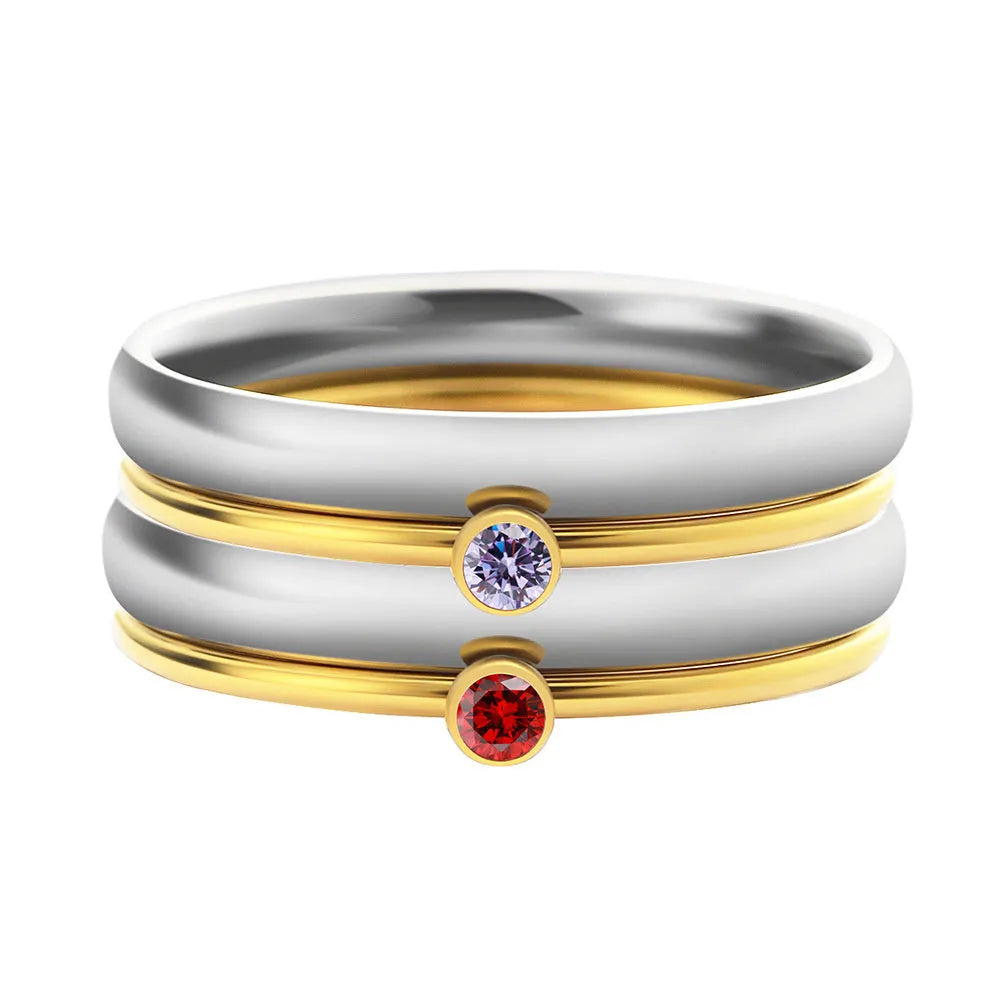 December birthstone geometric engraved ring in titanium steel on a grey background.