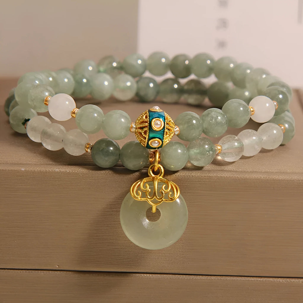 Women's green double-layer crystal bracelet with a peace buckle clasp and rhinestone details.