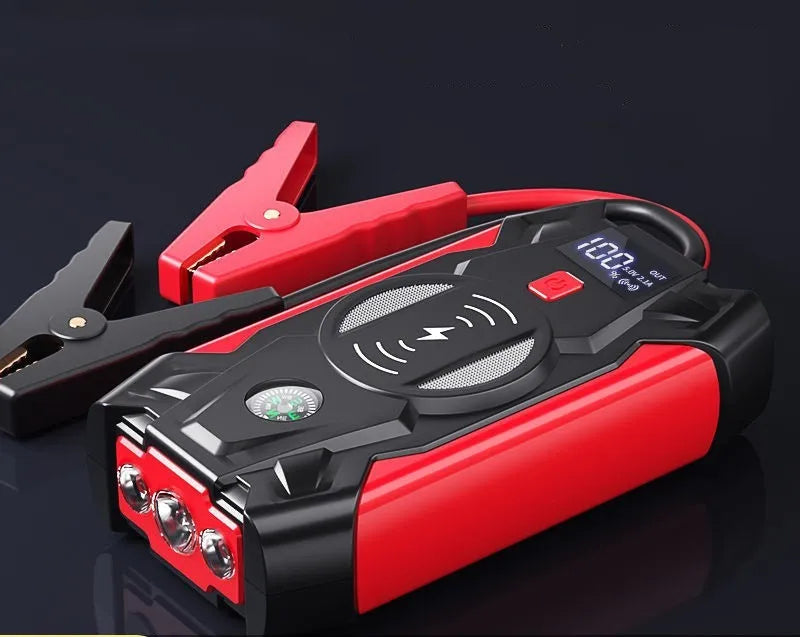 Red 12V car emergency jump starter power pack with battery clips and digital display