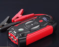 Red 12V car emergency jump starter power pack with battery clips and digital display