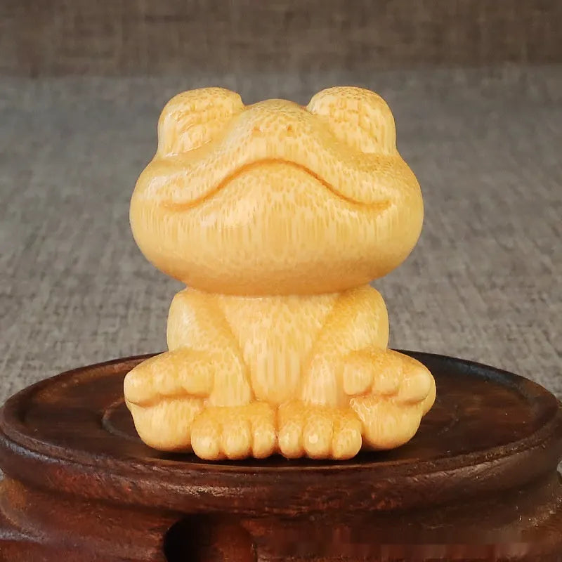 Solid bamboo smiling frog carving ornament next to a 120ml oil glove brush.
