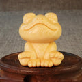 Solid bamboo smiling frog carving ornament next to a 120ml oil glove brush.