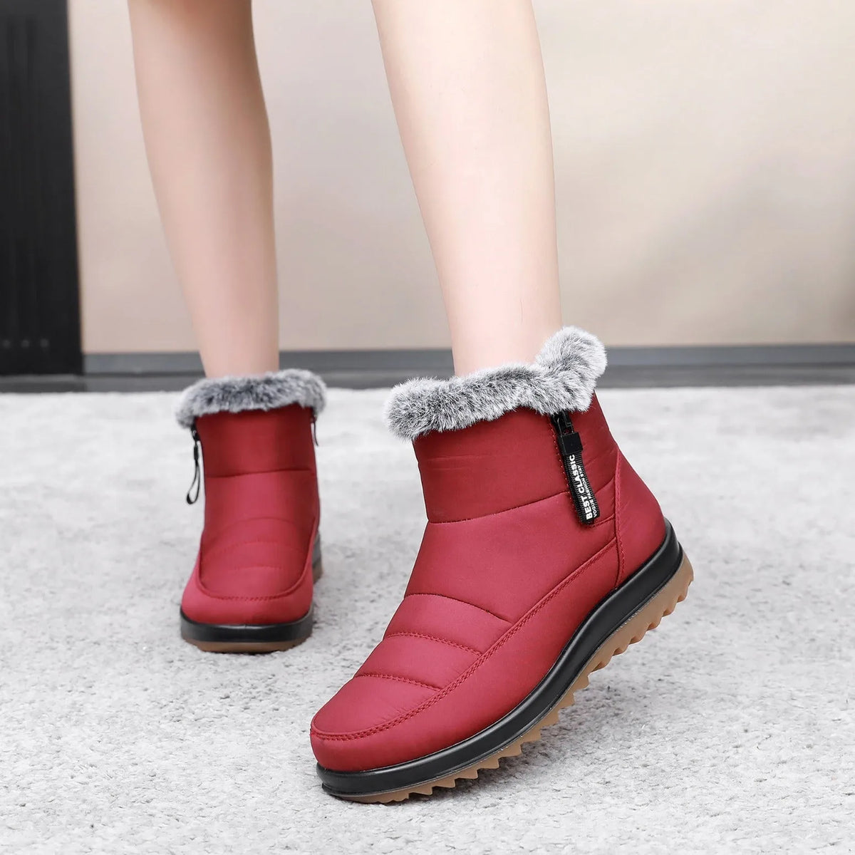Women's winter ankle boot with side zipper and fleece lining, shown in black, dark brown, and red.