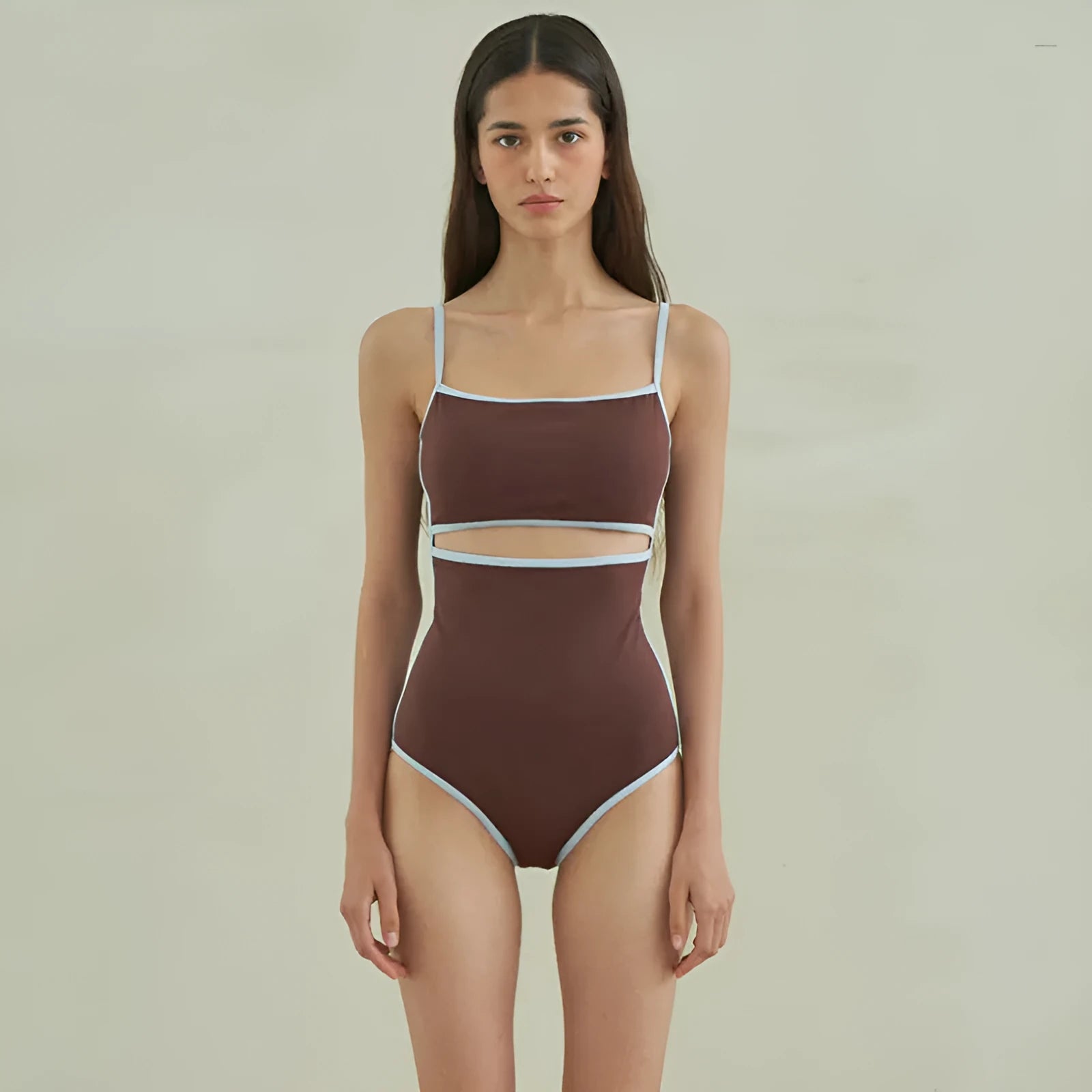 Brown women's triangle one-piece swimsuit on a hanger.