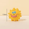 Four colourful latex squeaky dog toy balls with cute animal faces and textured surfaces