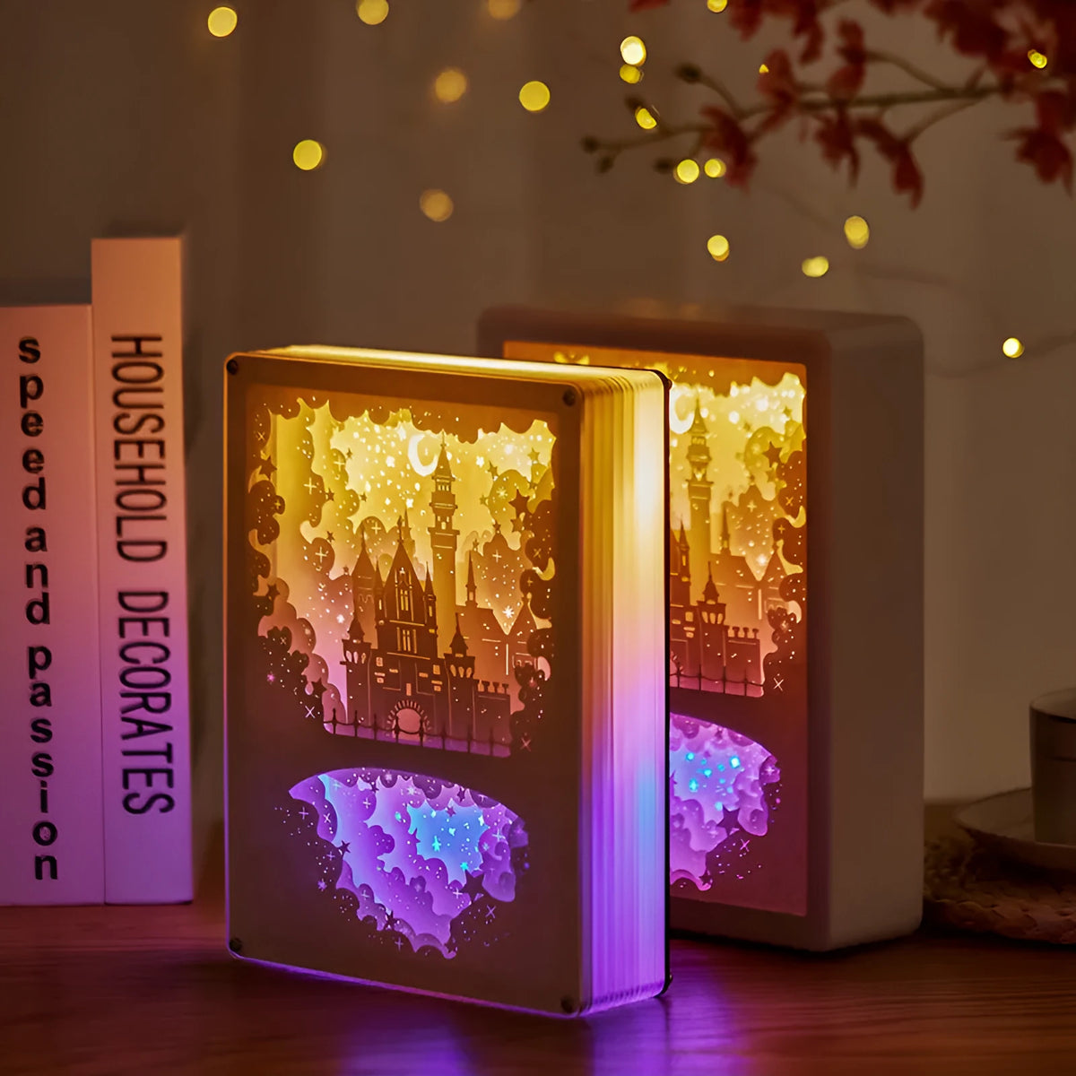 Modern bedside night light with 3D paper carving design on white plastic shade, showing yellow ambient glow.