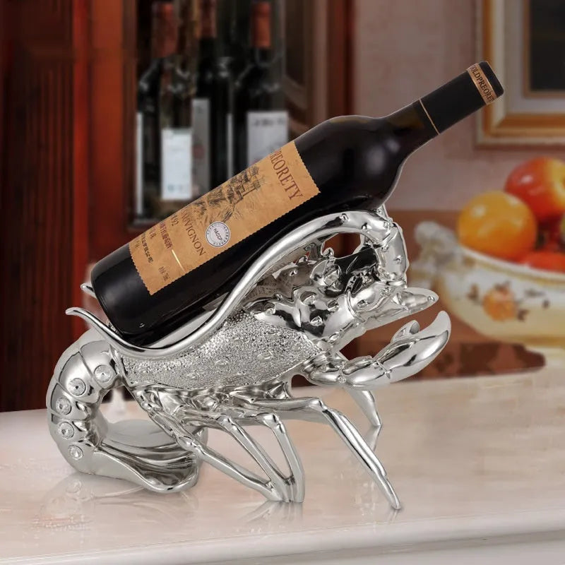 Lobster-shaped wine rack ornament in metallic rose gold or silver finish on display surface