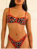 Women's cherry blossom print tube top bikini swimsuit set on a neutral background.