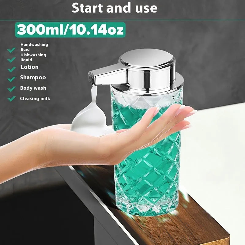 Silver automatic sensor soap dispenser with USB-C charging port on a bathroom counter.