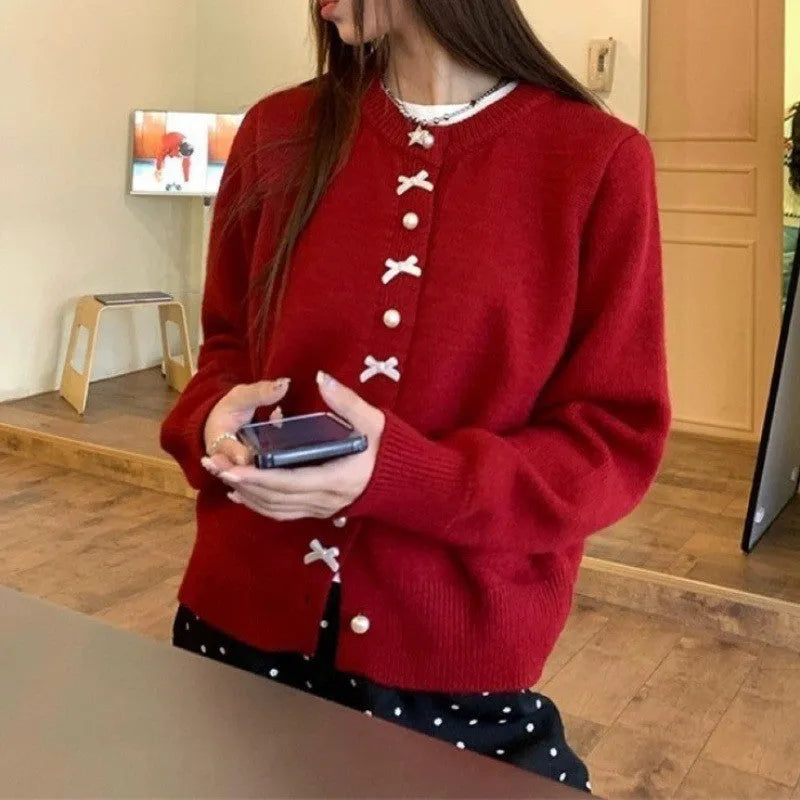Women's solid colour cardigan with pearl buttons and bow pattern detail on cashmere-style fabric