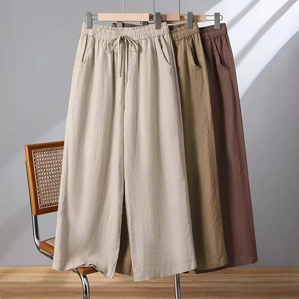 Women's apricot straight-leg casual trousers with a drawstring elasticated waist laid flat.