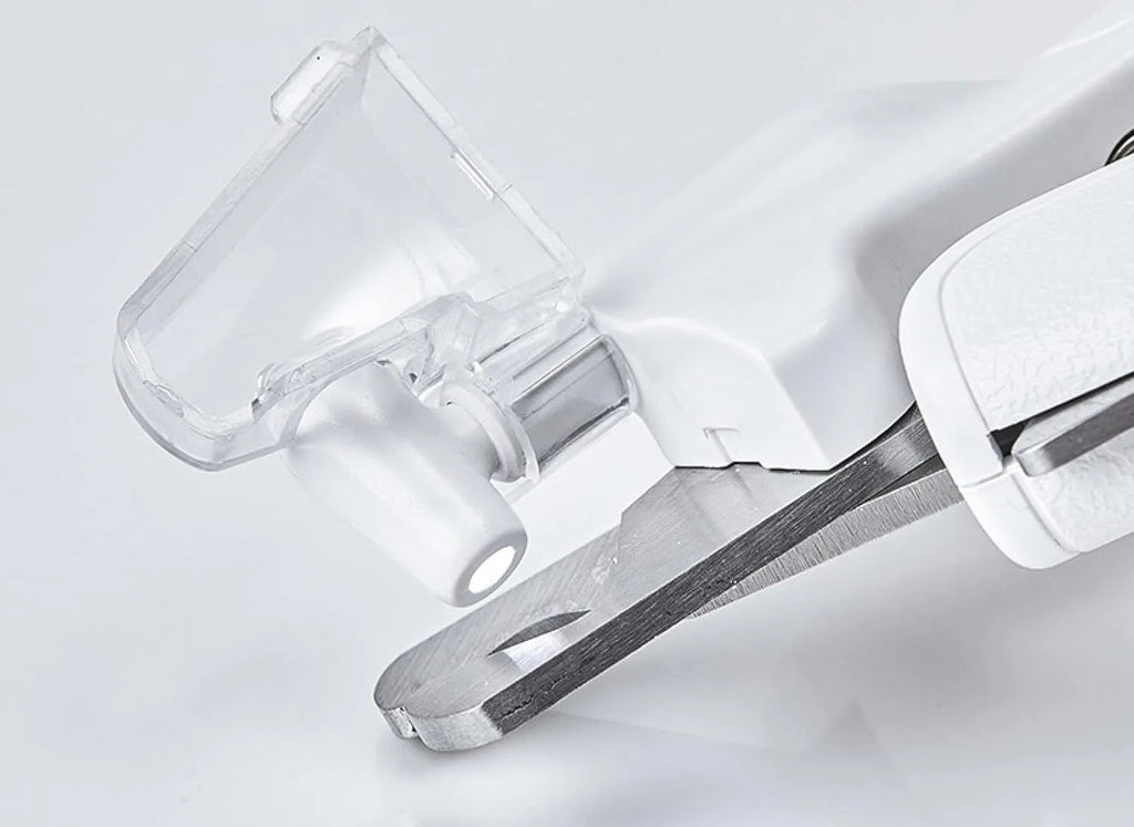 White LED pet nail clipper with transparent anti-splash guard open, showing triangular stainless steel blade