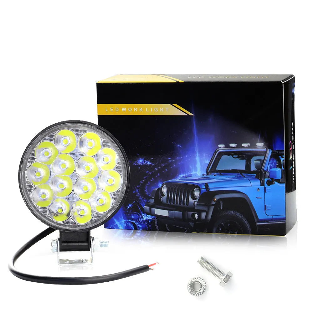 Compact round 42W LED work light with aluminium housing for car, truck, or motorcycle.
