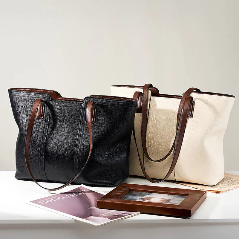 Women's black genuine leather horizontal square shoulder bag with crossbody strap showing internal organiser compartments.
