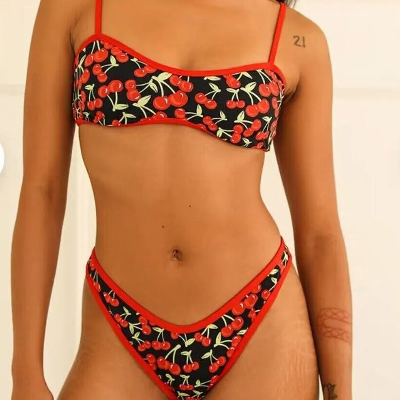 Women's cherry blossom print tube top bikini swimsuit set on a neutral background.