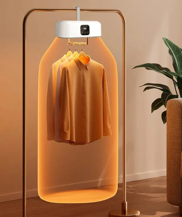 White cylindrical foldable clothes dryer with remote control on flat surface showing compact dimensions