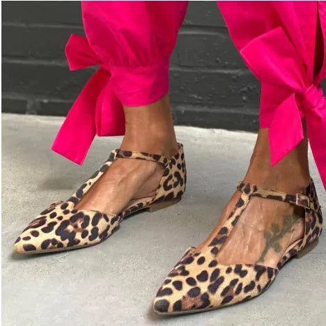 Leopard print women's pumps with pointed toe, chunky low heel, and cross shoulder straps.