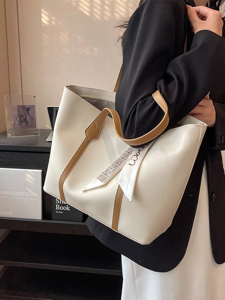 Large bucket-style tote bag with crossbody strap shown in multiple colour options