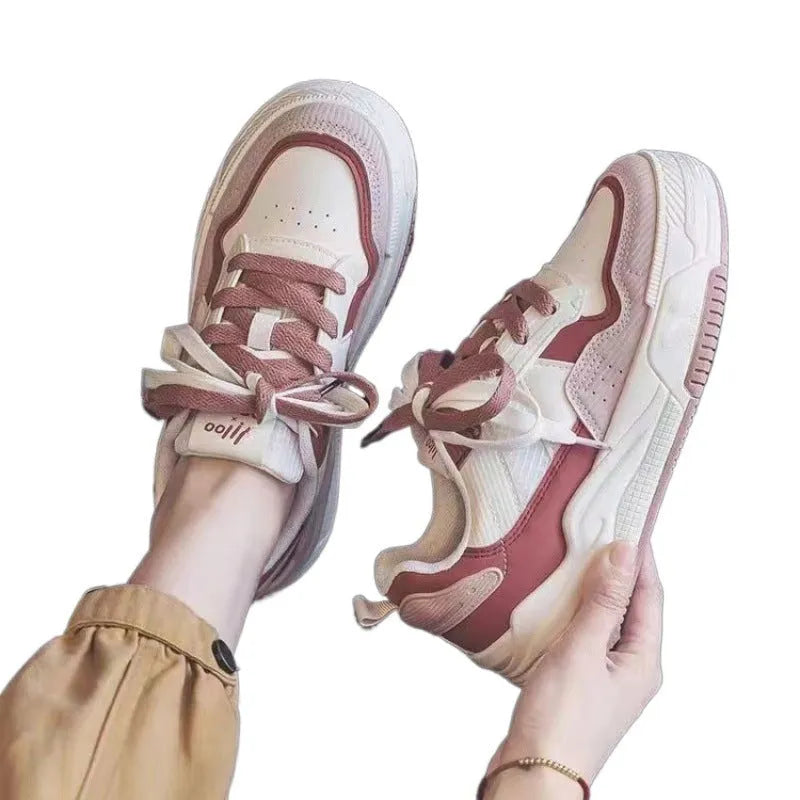Pink and beige low top sneakers with rubber soles and height-increasing design
