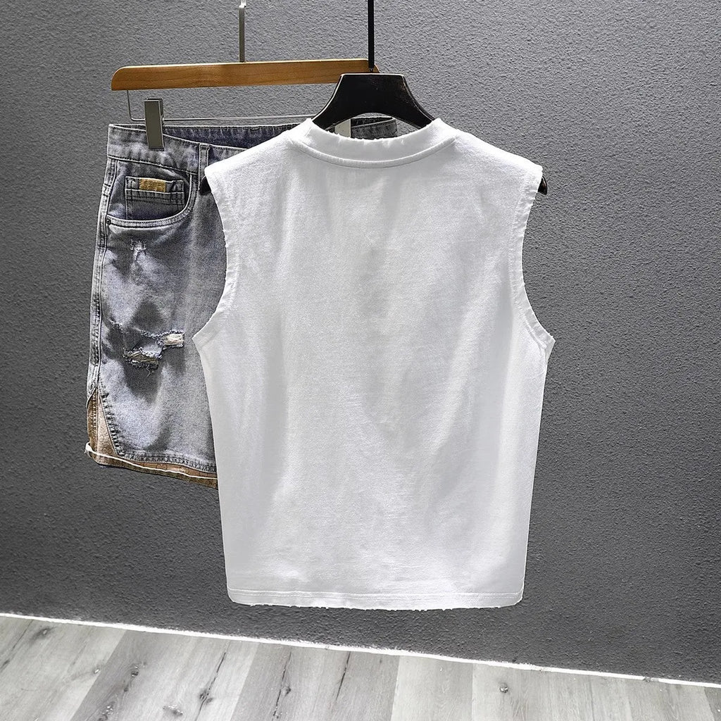 Loose fit solid colour cotton sleeveless t-shirt on a hanger, shown in white.