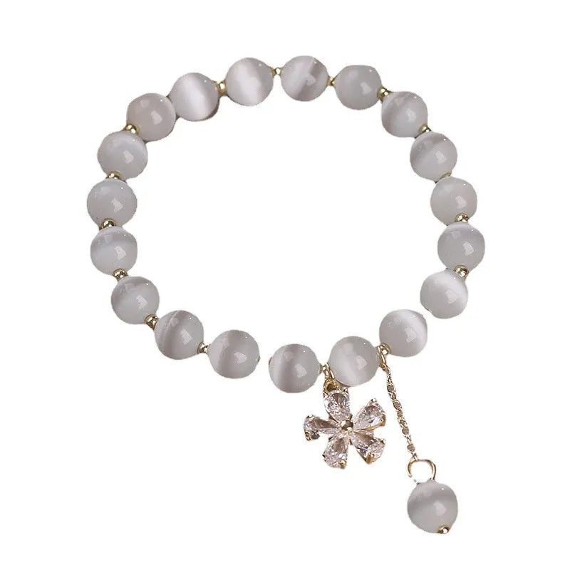 White Cat's Eye stone bracelet with flower tassel and morganite safety buckle.