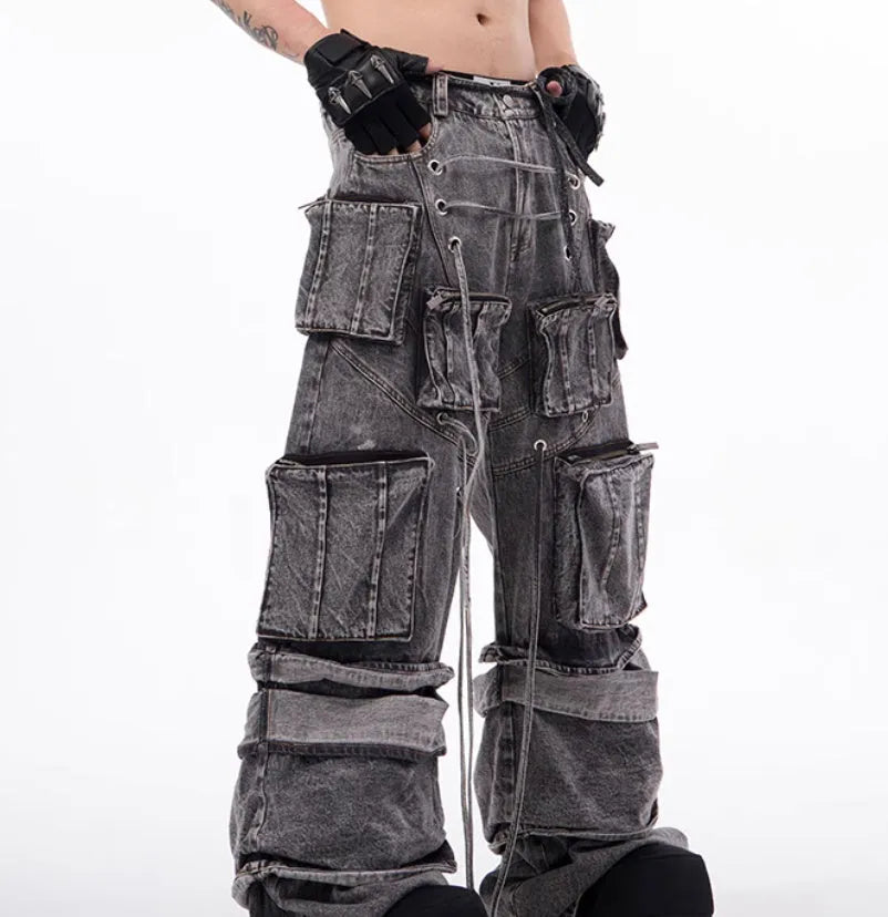 Grey distressed denim overalls with rope stitching on the legs, shown in a casual fit.