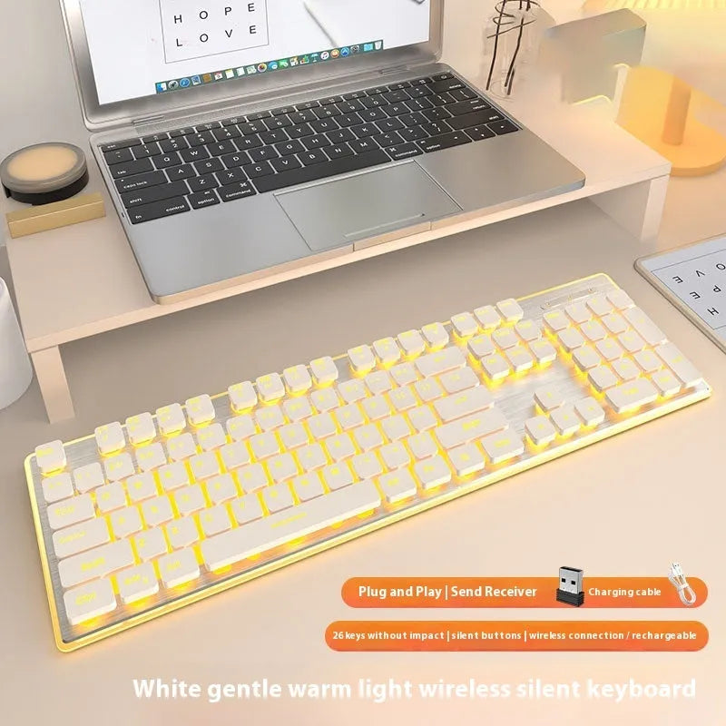 Wireless Bluetooth keyboard with mute button in cherry blossom pink colour on a desk.