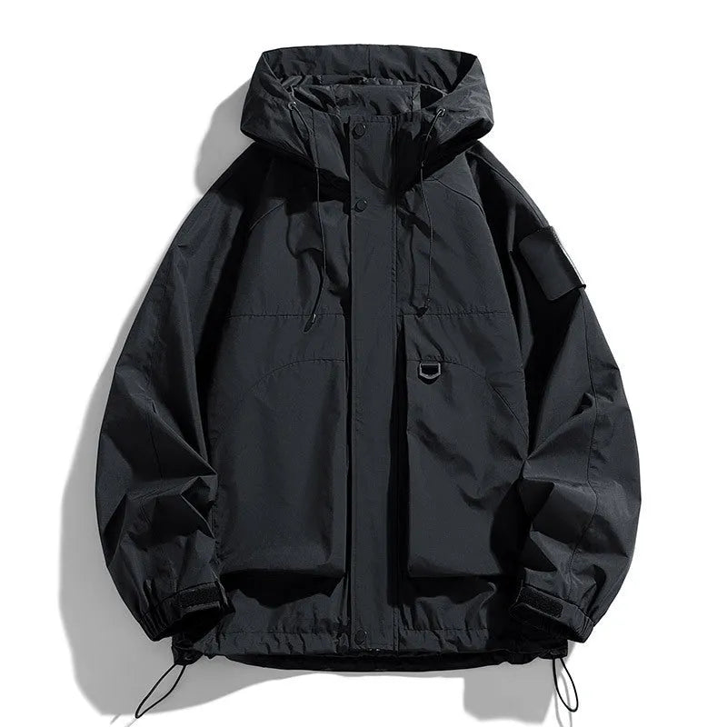 Man wearing a black waterproof windproof hooded jacket with long sleeves.