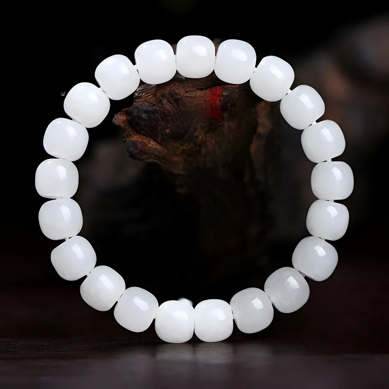 White Hetian jade barrel bead bracelet for men and women on a neutral background.