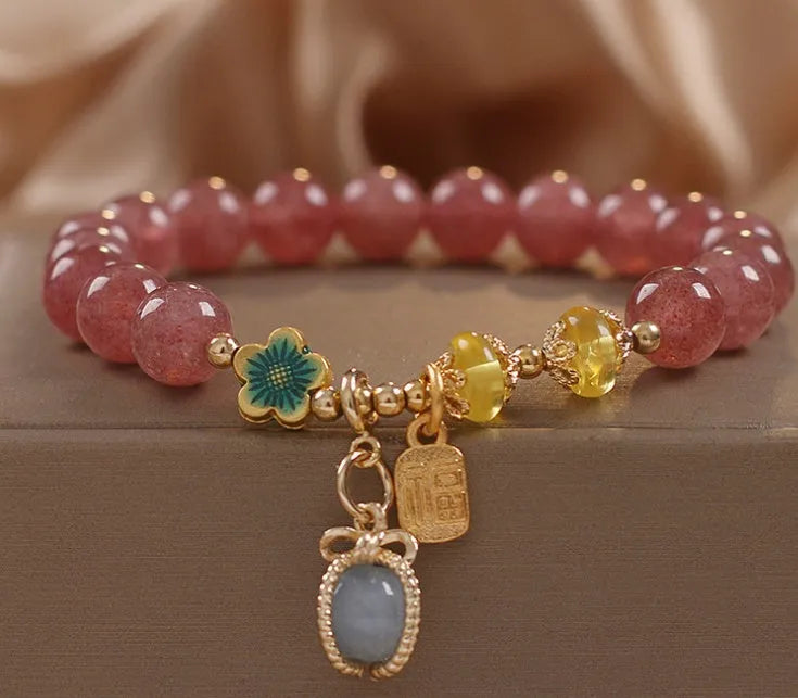 Red women's bracelet with strawberry quartz beads, alloy metal, and rhinestone detailing