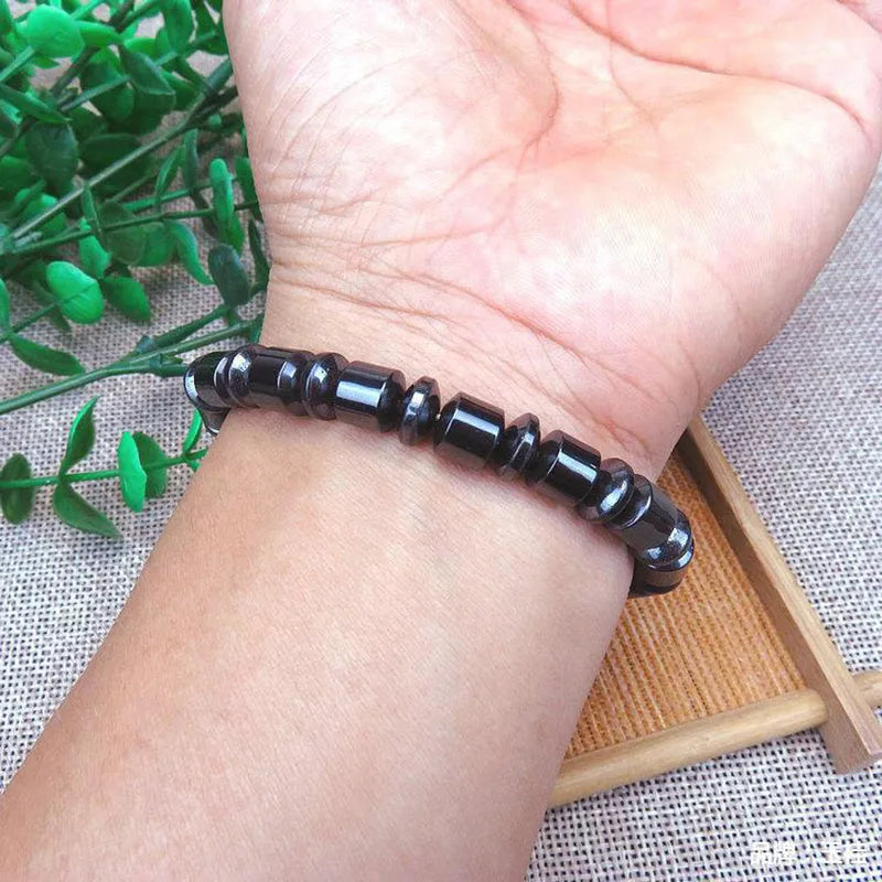 Black pentagram design magnetic therapy bracelet with magnetite and hematite stones on a stretch band.