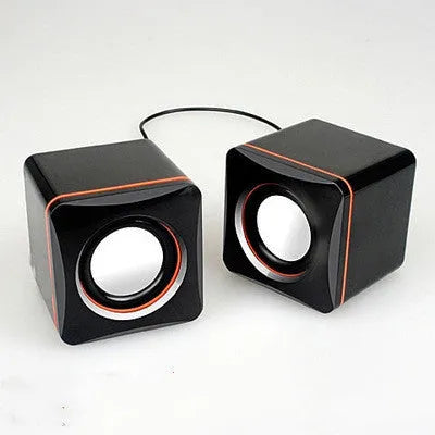 Black square USB-powered 2.0 computer speaker on desktop