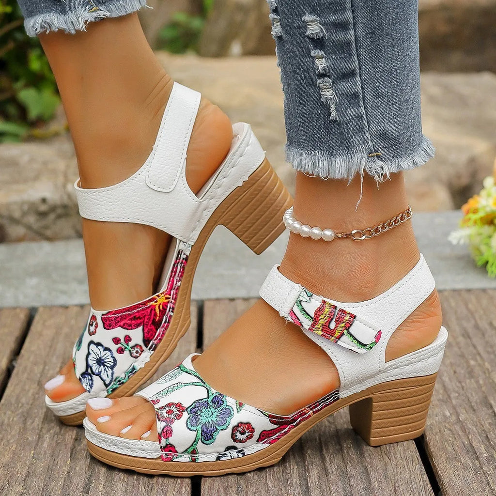 White women's high heel sandals with a velcro buckle strap and rubber sole.