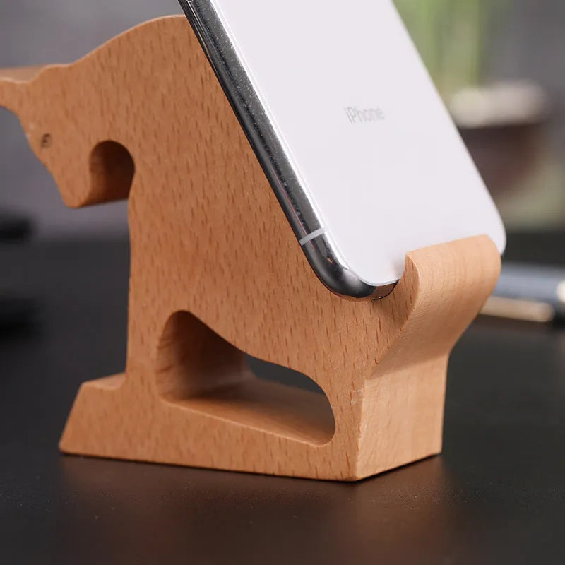 Solid beech wood mobile phone stand with a decorative resin animal ornament and a coin slot.
