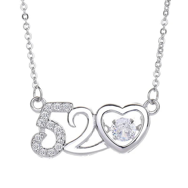Sterling silver heart-shaped pendant necklace with crown and bow details on an adjustable chain.