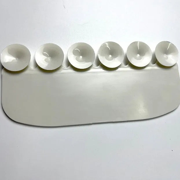 White PVC toilet urine splash guard board for boys potty training on a toilet seat.