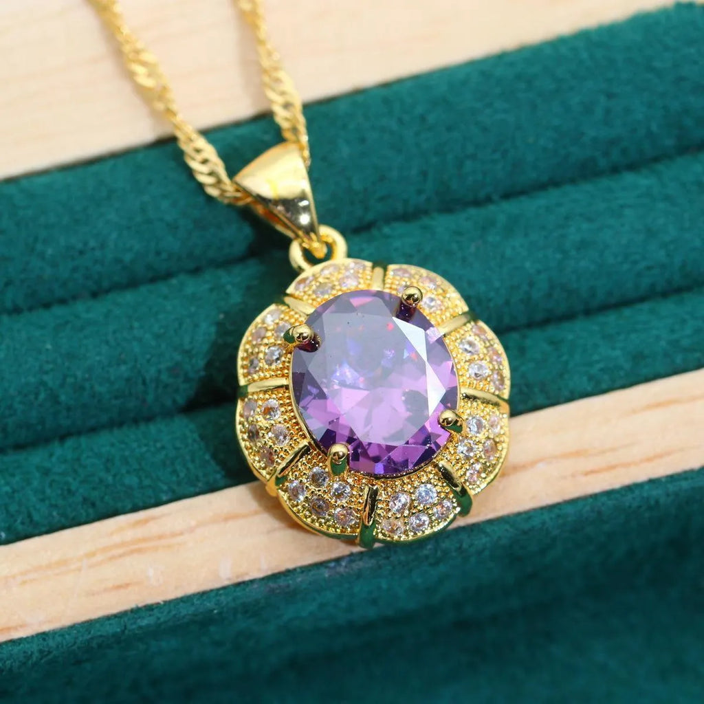 18k gold plated jewellery set with blue synthetic cubic zirconia stones, showing necklace, earrings, ring, and bracelet.