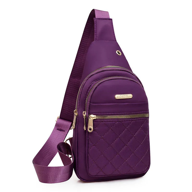 A girl's crossbody sports chest bag in Oxford cloth, shown in a choice of colours including black, dark blue, red, purple, and pink.