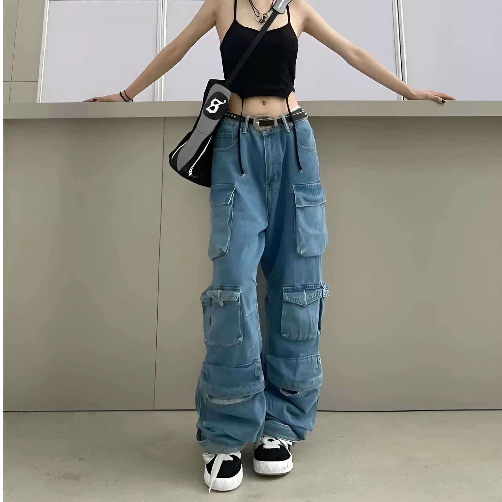 Women's blue high waist wide leg jeans with multiple pockets on a neutral background.