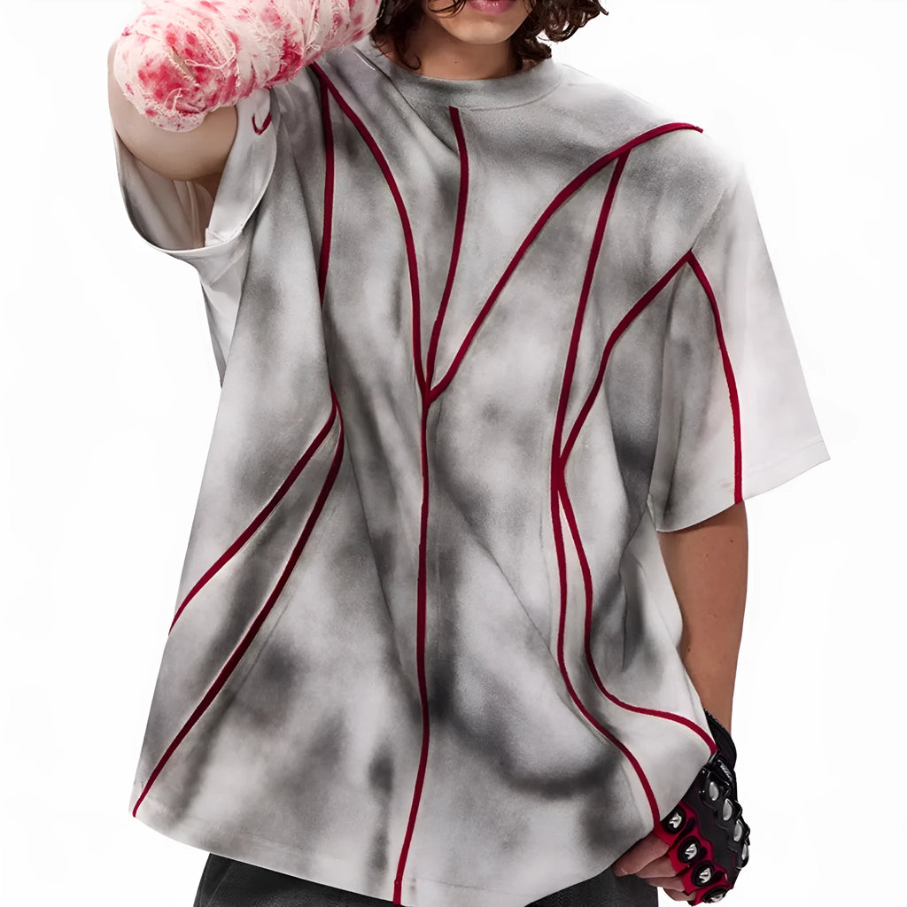 Women's grey padded shoulder t-shirt with textured patchwork design on the front.
