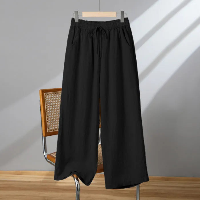 Women's apricot straight-leg casual trousers with a drawstring elasticated waist laid flat.
