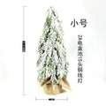 24-inch artificial Christmas tree with snow spray finish and integrated lights on desktop