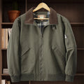 Plus size men's beige washed cotton baseball flight jacket on a hanger