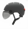 Cycling helmet with built-in rear LED brake light, shown in two style options.