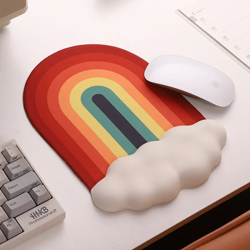 Silicone wrister mouse pad and keyboard support set with printed white cloud pattern on a desk.