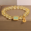 Women's yellow citrine crystal bracelet with rhinestone detailing on wrist